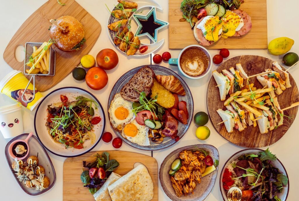 A colorful assortment of breakfast dishes and drinks in a Perth restaurant setting, showcasing diverse flavors.
